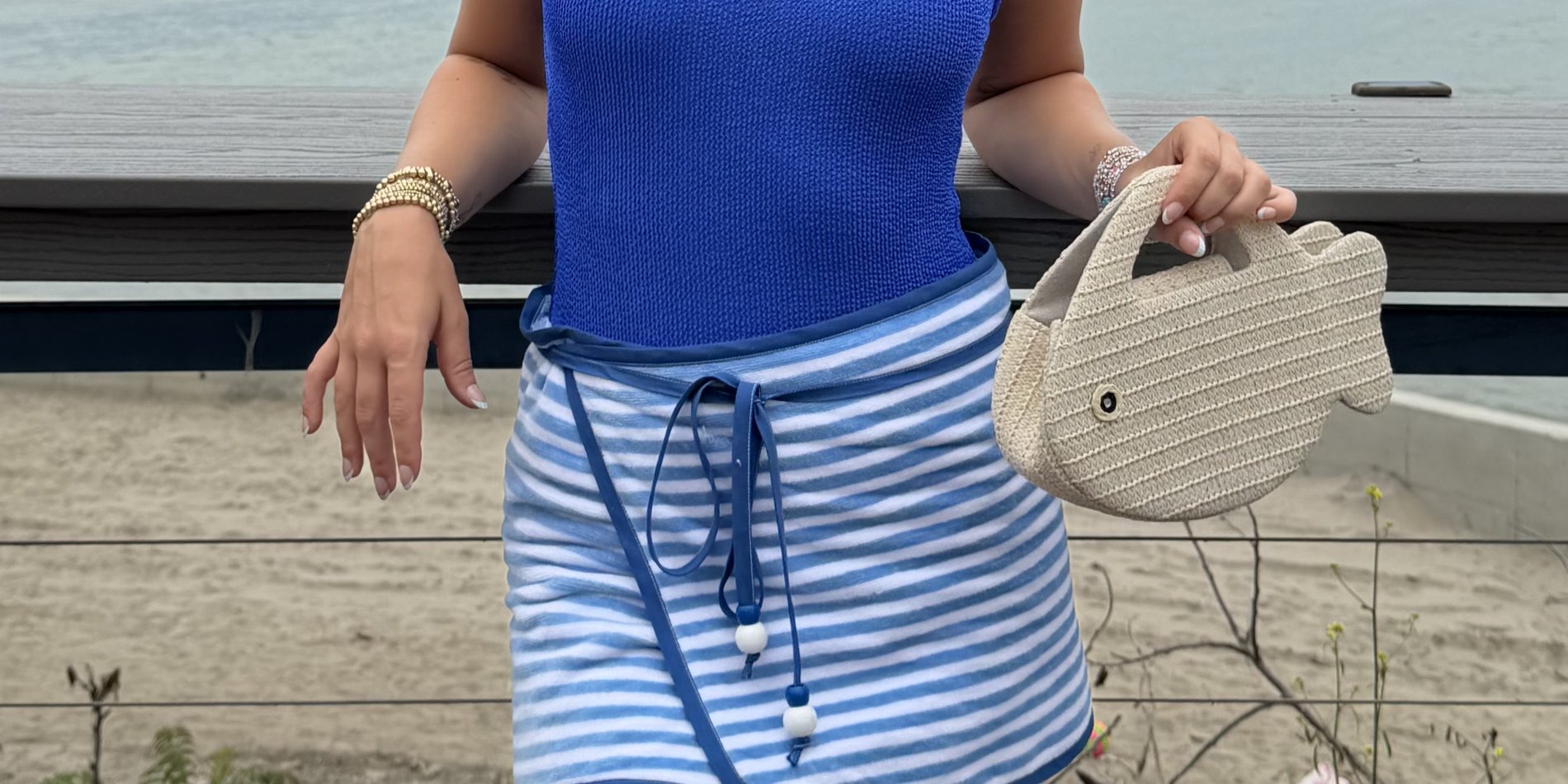 A blue and white striped hand-sewn towel wrap skirt worn by the water